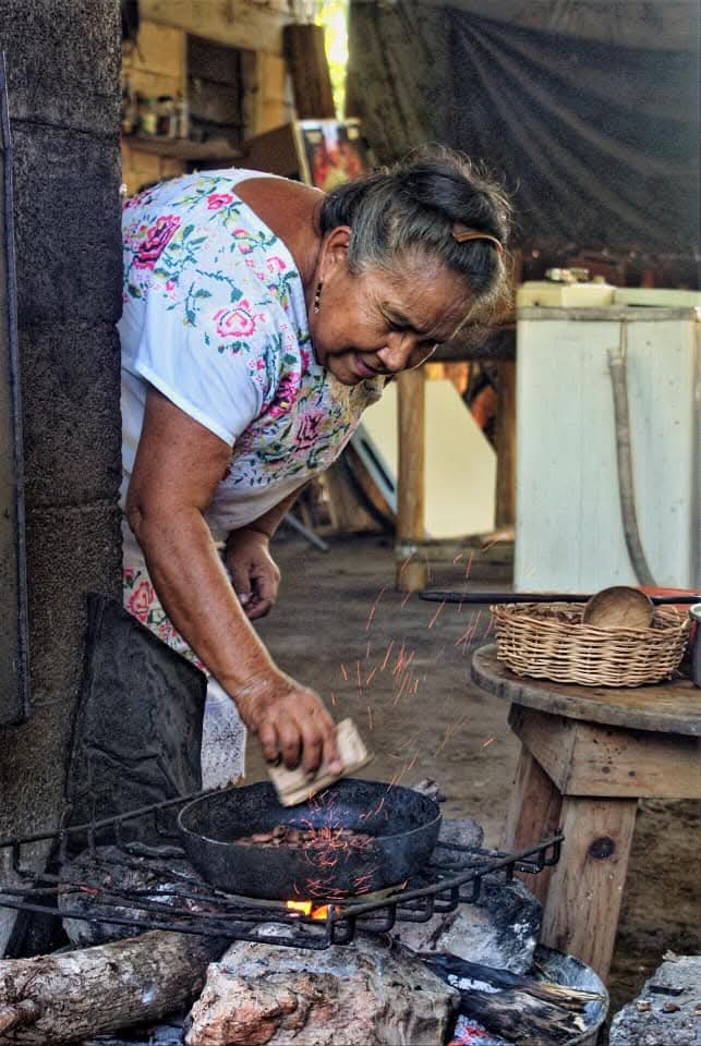 Local Maya women cooking on an outdoor fire stove